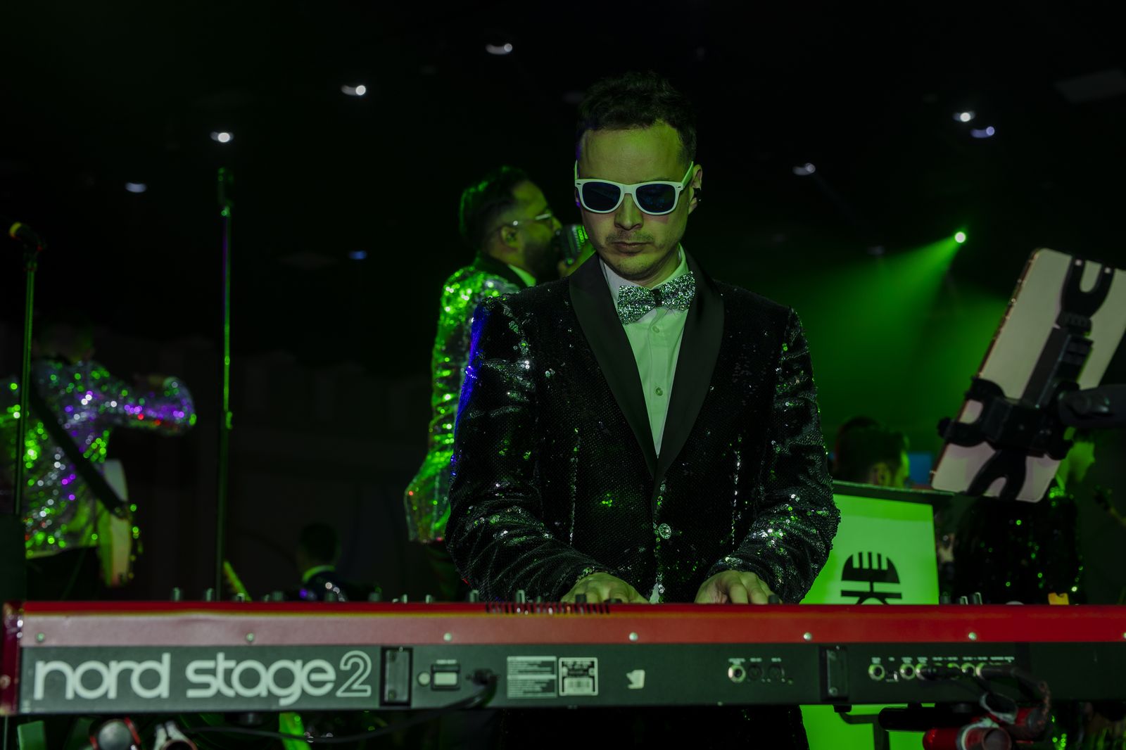 Wedding guests with hands up dancing to Memory Lane live music